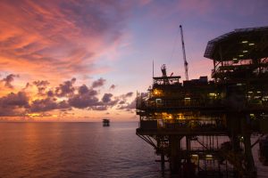 Silhouette of an offshore oil rig at sunset